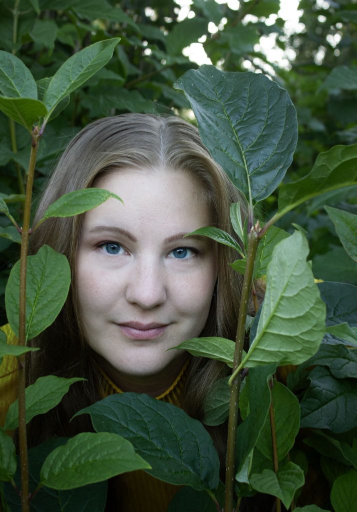 Iines peeking behind leaves.